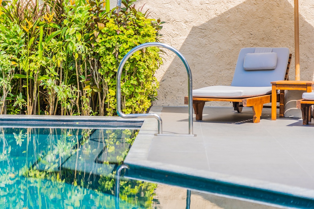 umbrella chair around swimming pool neary sea ocean beach with blue sky white cloud.jpg